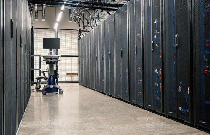 Steel framework cabinets housing servers networking devices and cables in contemporary equipped data center