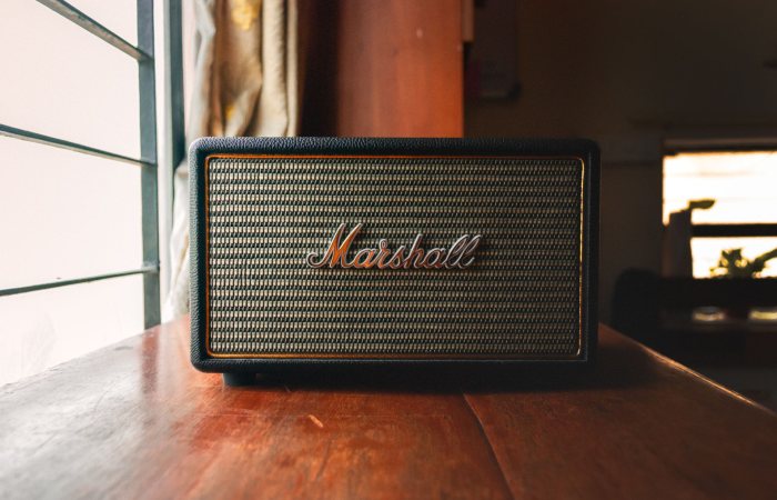 Close-up of a stylish Marshall speaker placed by a window, showcasing elegant audio design.