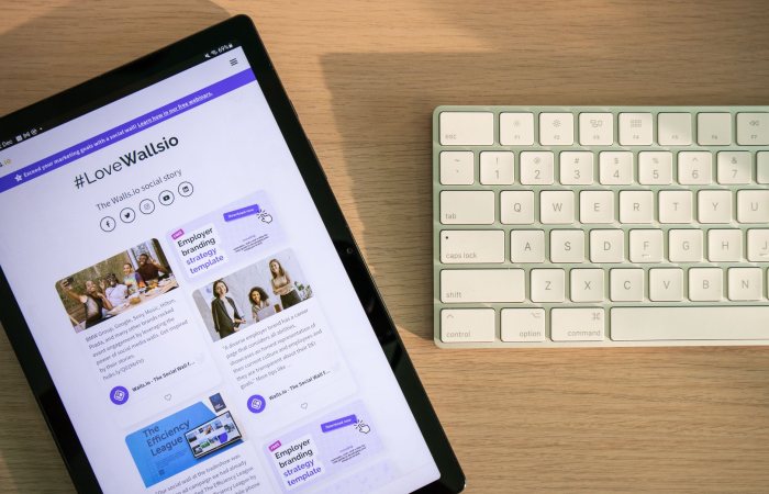Tablet displaying social media on desk with keyboard, highlighting connectivity and technology.