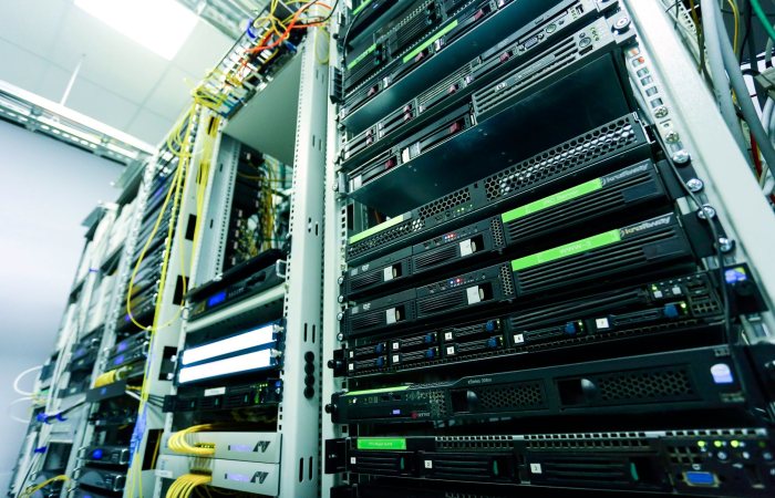 High-tech server rack in a secure data center with network cables and hardware components.